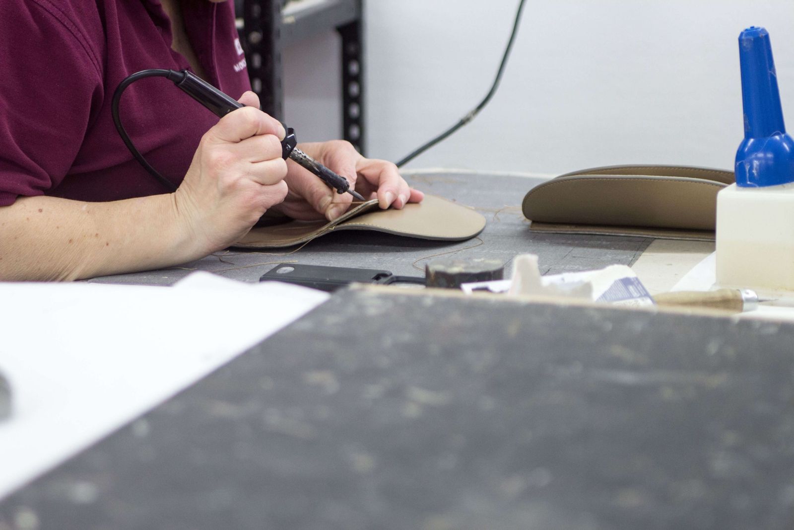 Hand finishing a leather panel