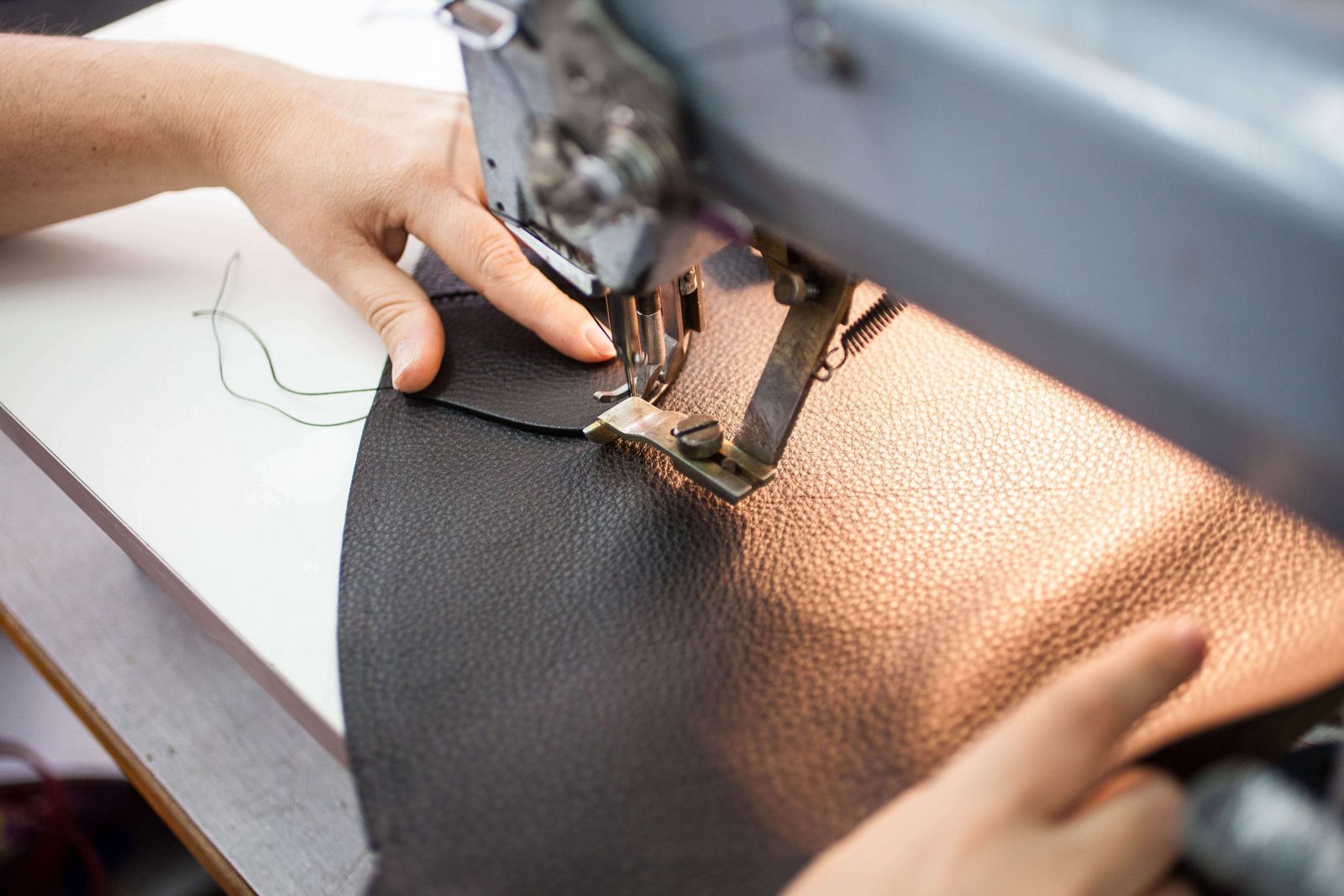 Stitching black leather on an industrial sewing machine